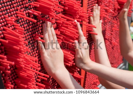 Children play a developing game for tactility.