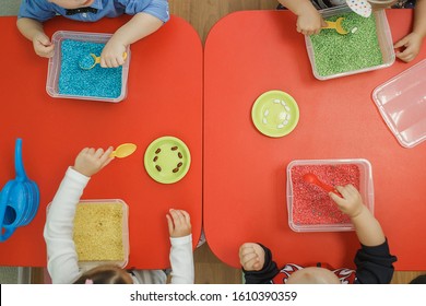 Children Play Educational Games With A Sensory Bin In Kindergarten.