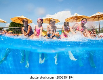 Children Play Fun With Splashes On The Side Of The Pool At The Resort