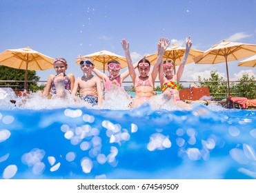 Children Play Fun With Splashes On The Side Of The Pool At The Resort