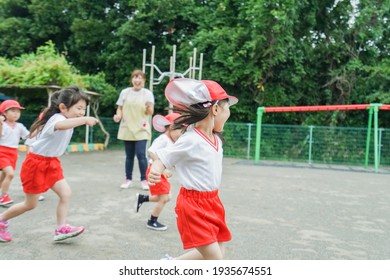 Children Play Outside At Nursery School