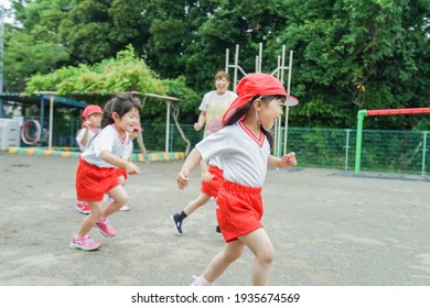 Children Play Outside At Nursery School