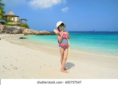 Children play in the sand at the beach.Kids playing water gun.Summer sea travel.Summer beach travel. 
