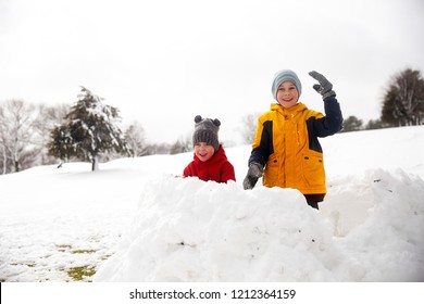 children play in the snow fort. snow battle. Winter fun. Cope space for your text - Powered by Shutterstock