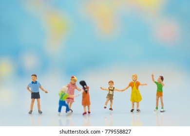 Children play together fun. backdrop is a map of the world, using as background International day of families concept. - Shutterstock ID 779558827