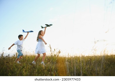 children play toy airplane. concept of happy childhood. children dream of flying and becoming a pilot - Powered by Shutterstock