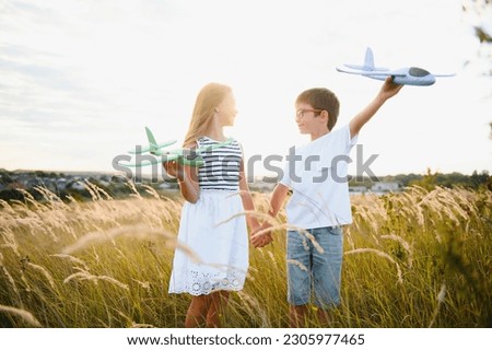 children play toy airplane. concept of happy childhood. children dream of flying and becoming a pilot