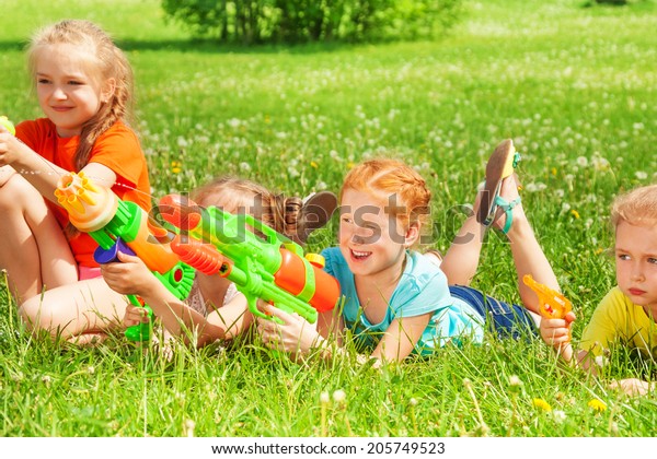 Children Play Water Guns On Meadow Stock Photo (Edit Now) 205749523