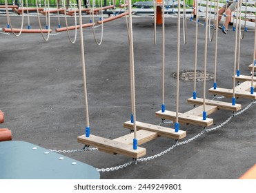 Children Playground with Modern Slide, Rope Net Bridge, Climbing Swings, Climbers. Empty Wooden Playground made of Eco Materials - Powered by Shutterstock