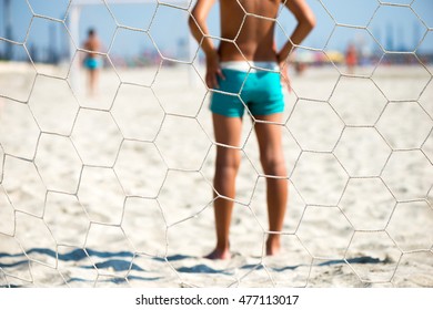 Children Playing Beach Soccer. View Behind The Goal