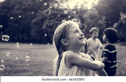 Children is playing bubbles in a park