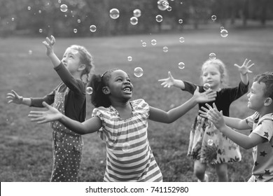 Children playing bubbles in a park
