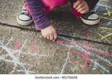 Children playing with colored chalks