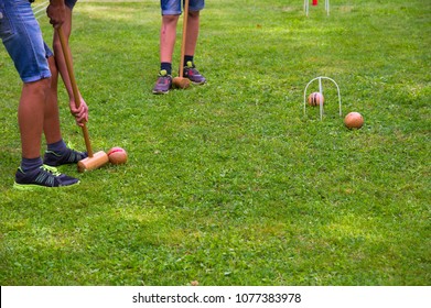 Children playing croquet in summer