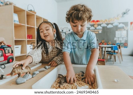 Children playing and developing tactility with toy animal figures in bulk cereals and pasta in kindergarten