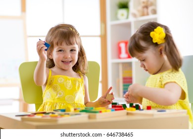 Children Playing With Developmental Toys At Home Or Kindergarten Or Playschool