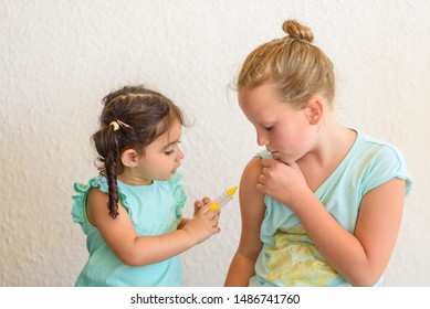 Children Playing Doctor. Doctor Injecting Vaccination Flu Shot In Arm Little Child Girl, Healthy And Medical Concept.