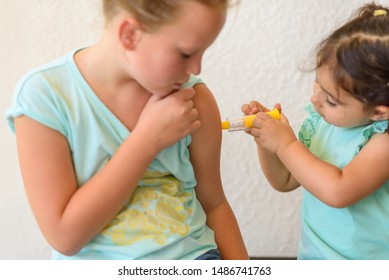 Children Playing Doctor. Doctor Injecting Vaccination Flu Shot In Arm Little Child Girl, Healthy And Medical Concept.