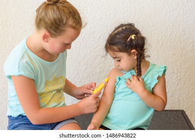 Children Playing Doctor. Doctor Injecting Vaccination Flu Shot In Arm Little Child Girl, Healthy And Medical Concept.