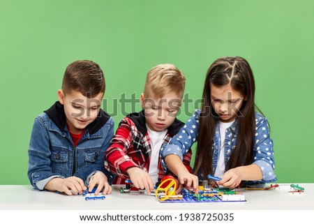 children playing with electronic constructor at studio