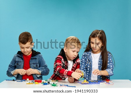 children playing with electronic constructor at studio