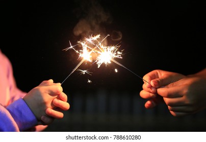 Children Are Playing With Fire Sparklers On The Festival.