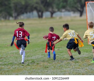 Children Playing A Flag Football Game Outside