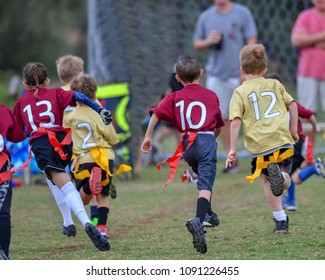 Children Playing A Flag Football Game Outside