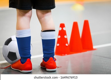 Children Playing Football In School Gymnasium. Indoor Soccer - Futsal Training For School Kids. Football Futsal Player, Ball, Futsal Floor And Training Cones