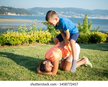 Children Playing Leapfrog On The Grass