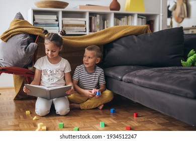 Children Playing In Living Room At Home