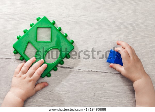 Children playing with\
montessori toys, educational toys, arranging and sorting colors and\
sizes.