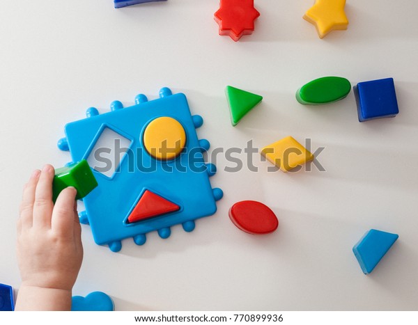 Children playing with\
montessori toys, educational toys, arranging and sorting colors and\
sizes.