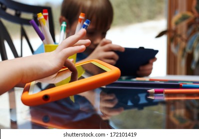 Children Playing On Digital Tablet At Home