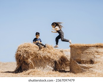 Children playing on hay bales - Powered by Shutterstock