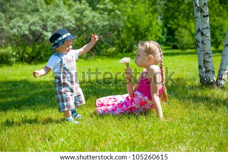 Similar – children playing in the sand, having a conversation over sand toys