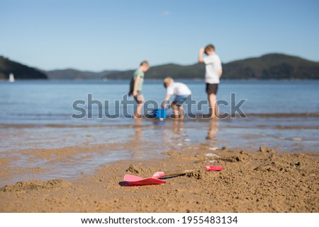 Children playing on the sand on a bright day