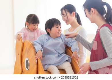 Children Playing On The Slide