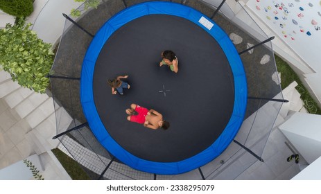 Children playing on trampoline aerial view together - Powered by Shutterstock