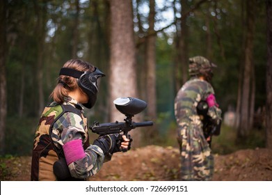 Children Playing Paintball In The Forest