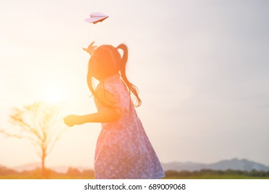 Children playing paper plane.The concept strengthens the imagination of children. - Shutterstock ID 689009068