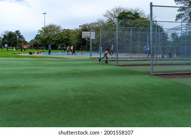 Children Playing At Park In Australian City Sydney During Covid Lockdown As On July 1 2021. Kids And Adults Using Public Park. Basket Ball Court And Cricket Nets Can Be Seen.