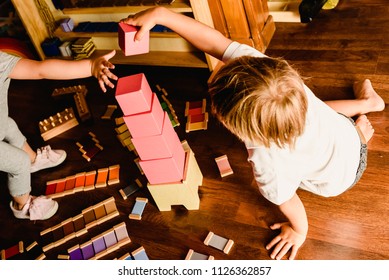 Children playing with pink tower in a Montessori class