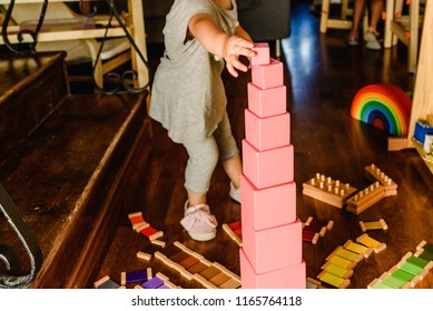 Children playing with pink tower in a montessori class