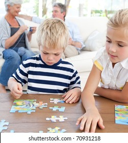 Children playing puzzle in the living room