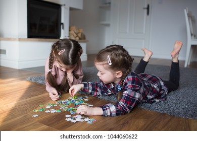 Children playing puzzles at home
