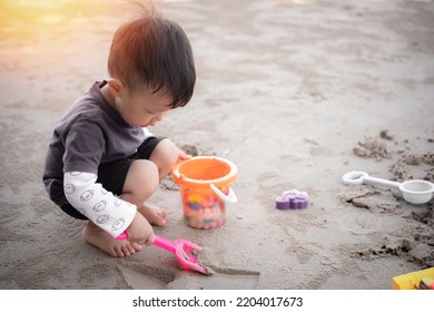 Children Playing In The Sand, Boy Playing With Sand Molds And Making Mud Pies,  Little Boy Playing Sand At The Beach With Sand Tools