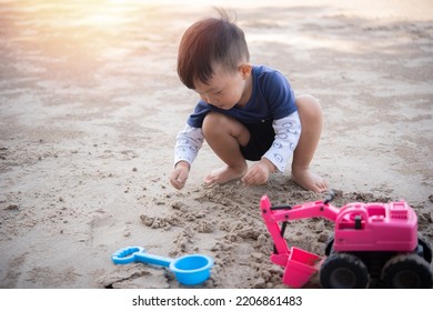 Children Playing In The Sand, Boy Playing With Sand Molds And Making Mud Pies,  Little Boy Playing Sand At The Beach With Sand Tools