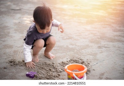 Children Playing In The Sand, Boy Playing With Sand Molds And Making Mud Pies,  Little Boy Playing Sand At The Beach With Sand Tools