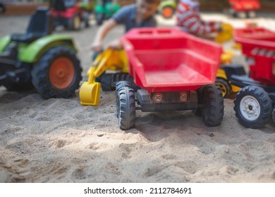 Children Playing In The Sandbox Sandpit, Kids With Toy Car Vehicle, Playground In Kindergarten Day Care